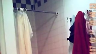 Voyeur captures a hot brunette naked in the bathroom