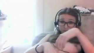 Nerdy glassed girl masturbates with a vibrator on the sofa