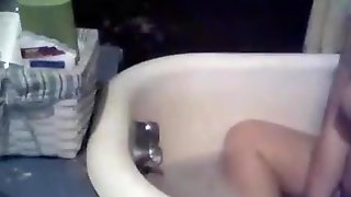 Chubby girl masturbates her hairy pussy with the waterbeam in the bathtub