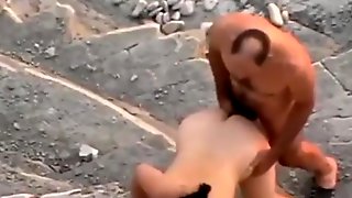 Voyeur tapes a nudist couple fucking in public near the rocks