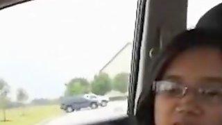 Nerdy asian girl with glasses sucks her black bfs cock in the car on a parking lot