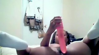 Big boobed black girl masturbates with a huge dildo on her bed