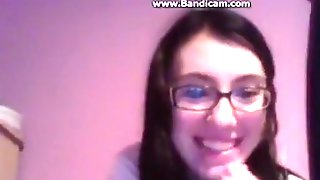 Nerdy brunette girl with glasses masturbates with a dildo for her bf on skype