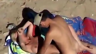 Voyeur tapes a nudist couple having missionary sex at the beach