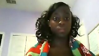 Ebony girl masturbates with a vibrator on her bed
