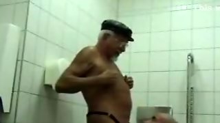 Mature gay men fuck in a public toilet