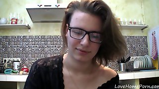 Solo girl with glasses chatting in the kitchen 