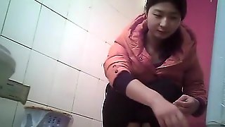 Asian girl with hairy pussy spied in toilet pissing