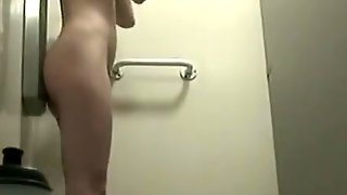 Woman in shower cabin washing her tight body