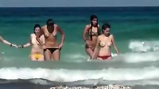 Topless girls running in the water