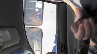 Guy strokes his cock in traffic next to woman in bus