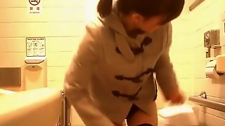 Asian woman caught in public toilet peeing