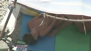 Nudist couple caught fucking under tent