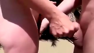Beach handjob makes his hard dick cum