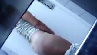 Fat ass teacher flicks her clit in the college toilet