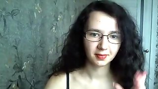 Dorky brunette in glasses chats on her live cam in her bra