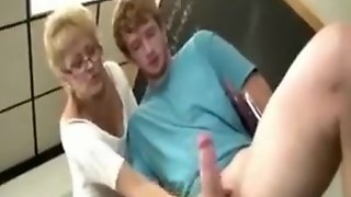 Blonde mature teacher beating student in class room