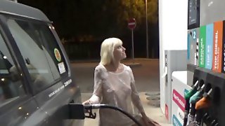 Blonde in a transparent dress fills the car at gas station