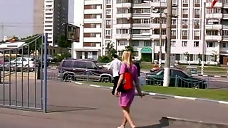 Beautiful blonde walking barefoot in town.