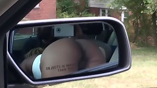 Black slut sucking dick in car. View of ass.