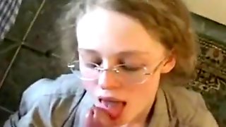 Young babe with glasses swallows thick penis