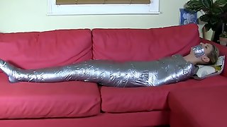 Blonde mummified on sofa