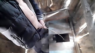 Russian guy pisses in a rustic toilet