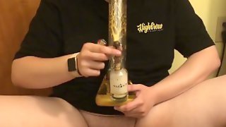Stoner girl smokes weed out of water pipe to relax