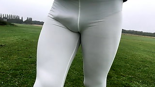 Walking in a public park in white leggings.