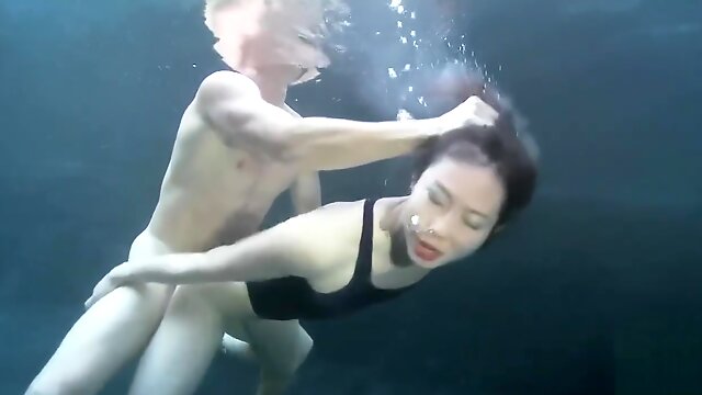 Swimsuit girl sex with a guy underwater