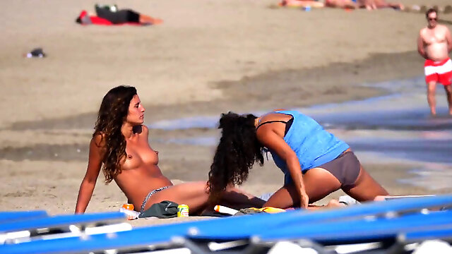 Steamy tanned lezzies Kissing on Topless Beach