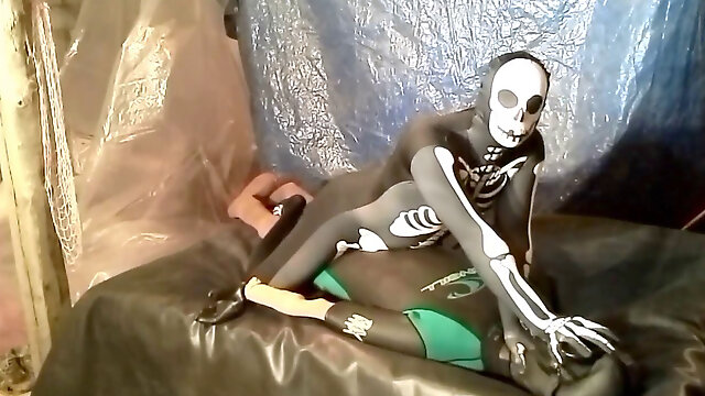 Desire scene where latex skeleton wrestles and screws frogman