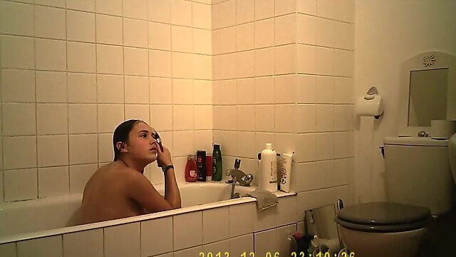 Brunette cutie enjoys a hot shower in the bathroom