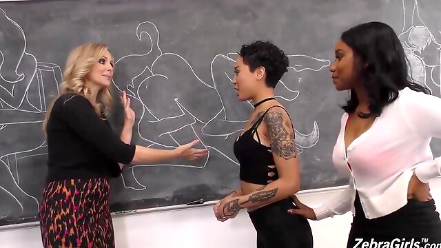 Lusty lesbians are having an interracial threesome in the classroom, while no one is watching them