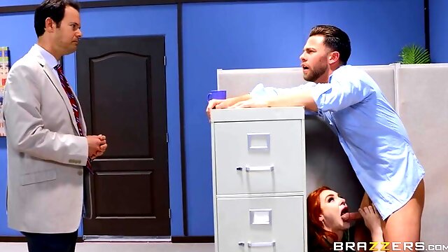 A red headed babe makes love with her co-worker in the office