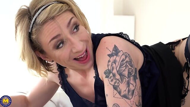 Tattooed blonde mature, Julie Holly likes the way a handsome guy is fucking her brains out