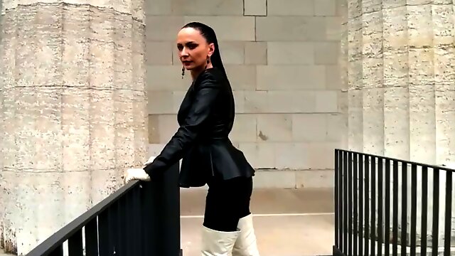 Mistress walking in high white boots