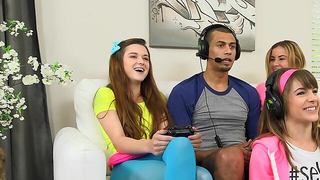 Three teen babes seduce a gamer and suck his huge dick