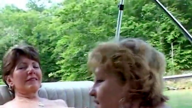 Busty mature lesbians on a boat