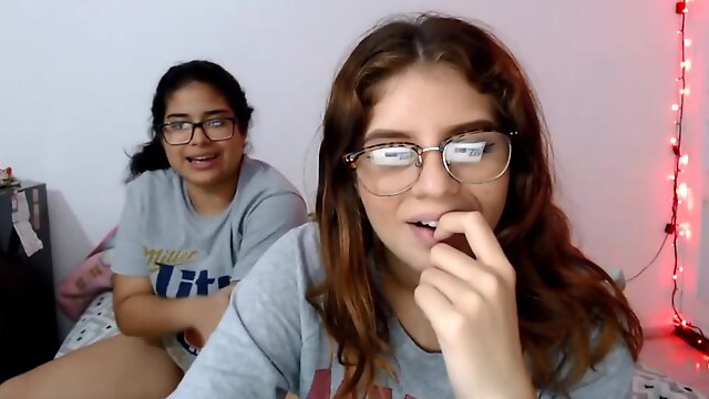 Two nerdy latinas playing with their pussies on cam