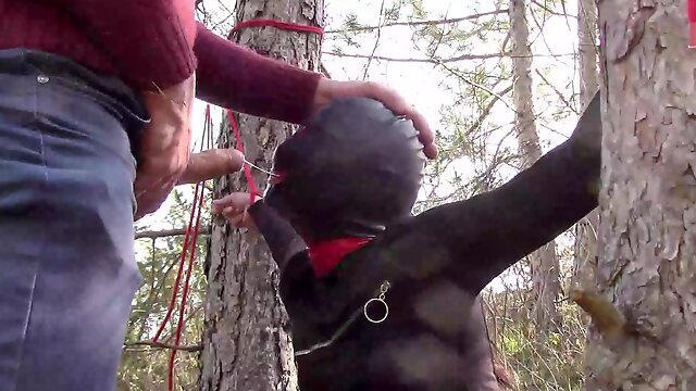 Tied to a tree on a sexy outfit, masked and outdoor deepthroat with no mercy