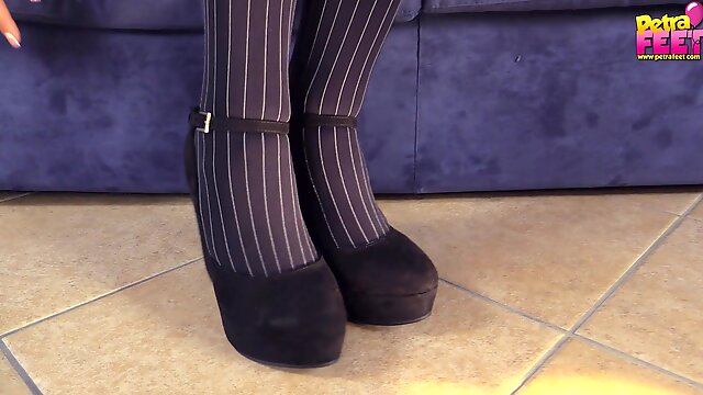 Striped blue pantyhose are beautiful on her soft feet