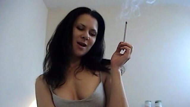 Horny brunette mom gives a blowjob after smoking a cigarette