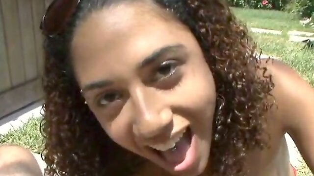 Curly-haired Latina gives hand to some dude in the yard