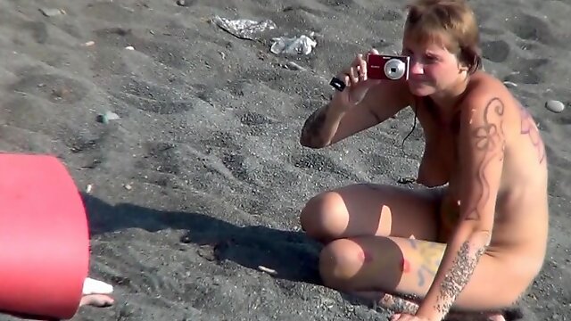 MILF nudist is getting naked on the beach