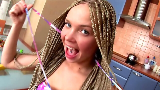 Teen wearing braids masturbates with a fruit in the kitchen