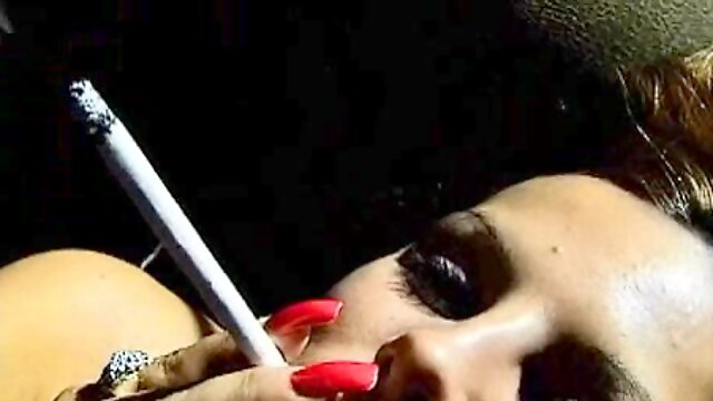 Naked solo girl is smoking while fingering her pussy