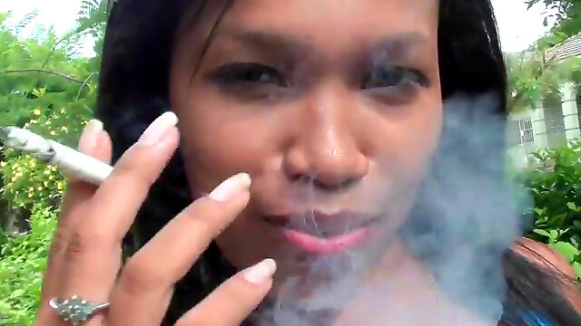 Ebony is smoking a cigarette