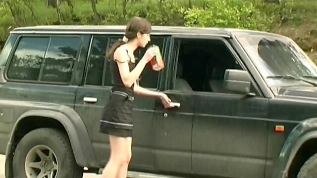 Smoking chick pissing outside her car