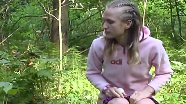 Braided hair girl pisses in the woods